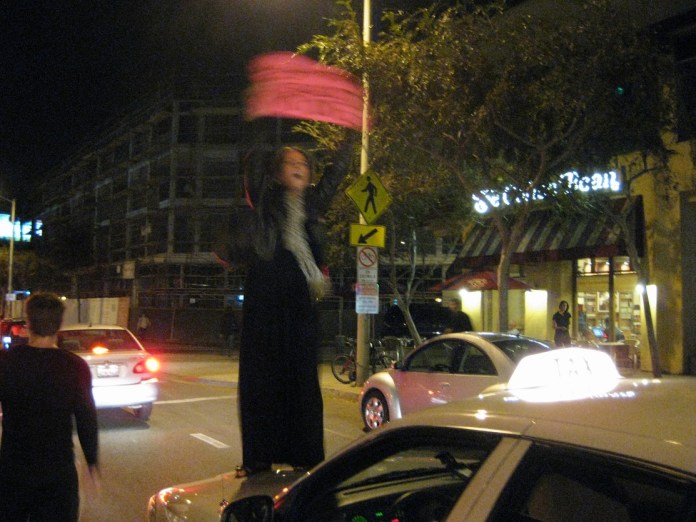 she asked if she could climb onto his hood, but the taxi driver thought she was asking for a ride and yelled at her to get down